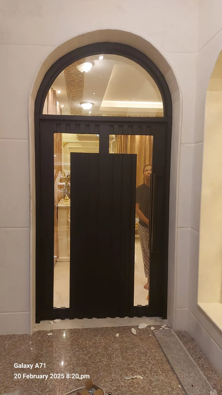 Arched entrance door with decorative metalwork