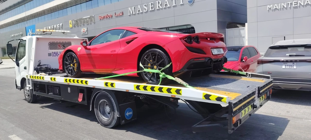 Red sports car on a recovery flatbed