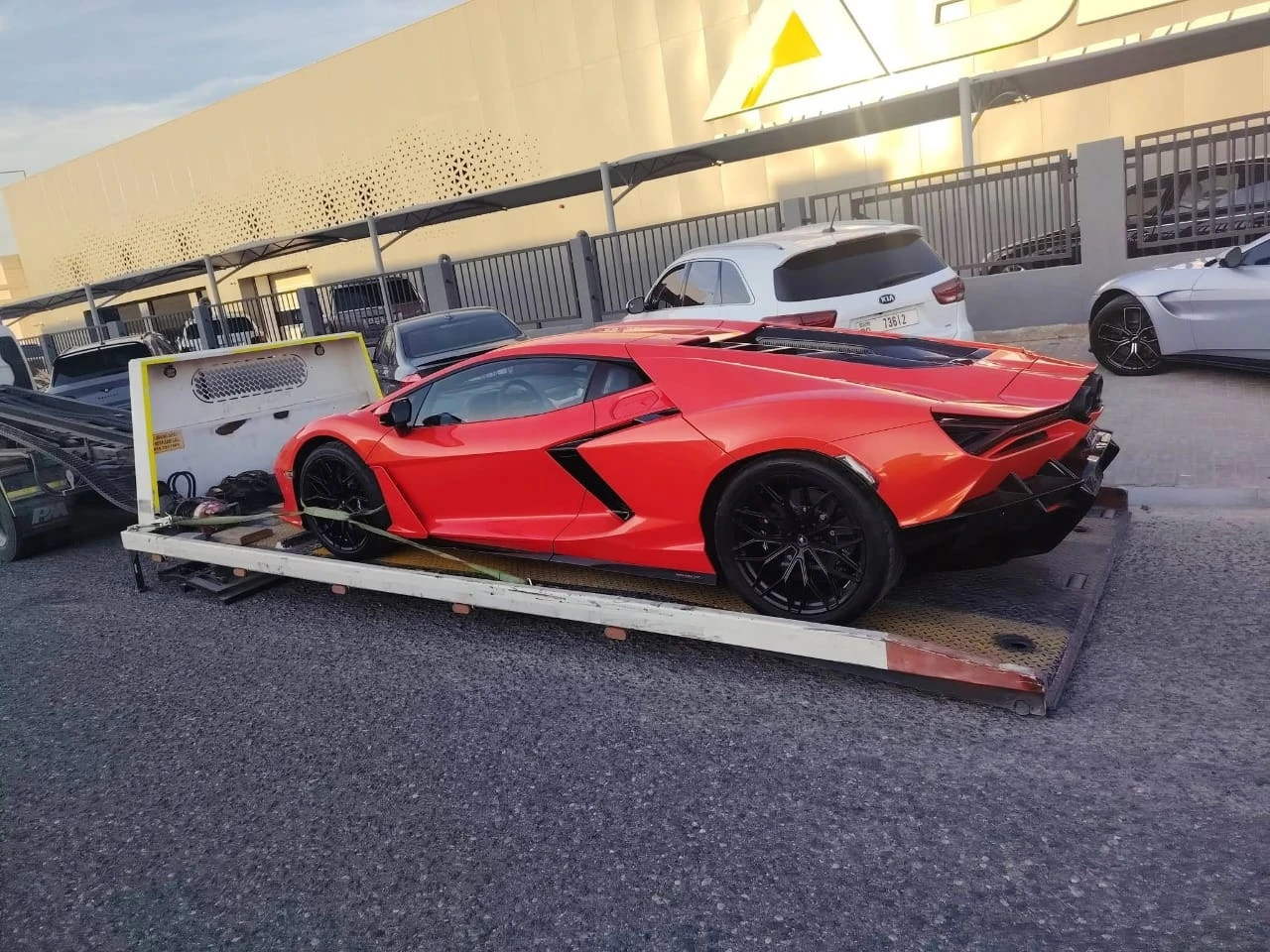 Red sports car secured for transport