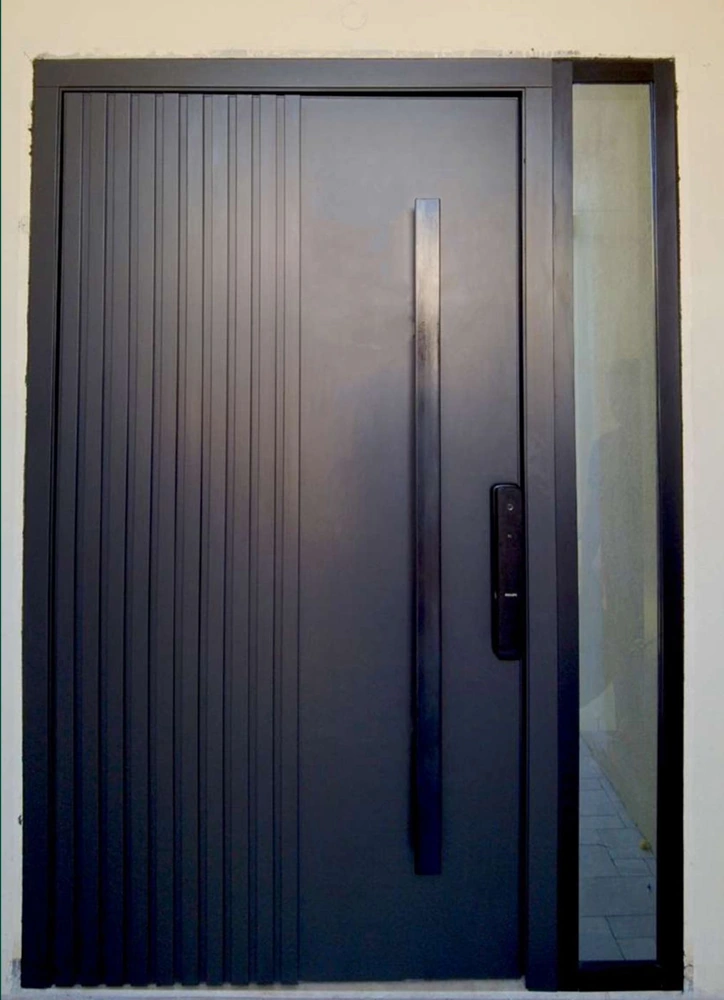 A dark vertically ribbed entrance with a long handle and lock panel.